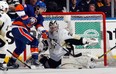 New York Islanders forward Matt Moulson, left, tries to get the puck on Pittsburgh Penguins goalie Marc-Andre Fleury during Game 4 of their NHL playoff series May 7, 2013, in Uniondale, N.Y. Photo by Bruce Bennett, Getty Images