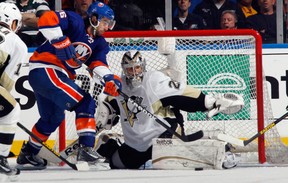 New York Islanders forward Matt Moulson, left, tries to get the puck on Pittsburgh Penguins goalie Marc-Andre Fleury during Game 4 of their NHL playoff series May 7, 2013, in Uniondale, N.Y. Photo by Bruce Bennett, Getty Images