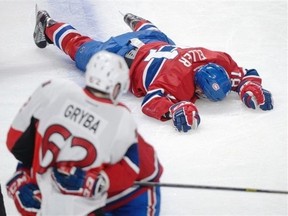 Montreal Canadiens' Lars Eller lies injured on the ice following a hit by Ottawa Senators' Eric Gryba (62) during NHL playoff action in Montreal, Thursday, May 2, 2013. Montreal Canadiens coach Michel Therrien accused Ottawa Senators counterpart Paul MacLean of "disrespect" on Friday for his comments about a hit that put Habs centre Lars Eller in hospital. THE CANADIAN PRESS/Graham Hughes