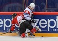 Taylor Hall gets undressed by the immortal Sabahudin Kovacevic of Slovenia. (Photo by Andre Ringuette/HHOF-IIHF Images)