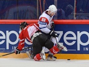 Taylor Hall gets undressed by the immortal Sabahudin Kovacevic of Slovenia. (Photo by Andre Ringuette/HHOF-IIHF Images)