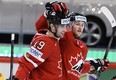 Justin Schultz and Steven Stamkos celebrate after teaming up on the game-winning goal against Sweden on Thursday. (Photo: The Canadian Press)