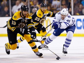 James van Riemsdyk #21 of the Toronto Maple Leafs and Zdeno Chara #33 of the Boston Bruins reach for the puck in the second period in Game Seven of the Eastern Conference Quarterfinals during the 2013 NHL Stanley Cup Playoffs on May 13, 2013 at TD Garden in Boston. Photo by Jared Wickerham, Getty Images