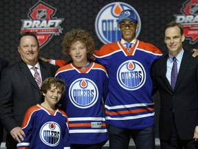 Darnell Nurse with Edmonton Oilers executives Scott Howson and Stu MacGregor at the 2013 NHL Draft. (Photo: Bill Kostroun/AP)