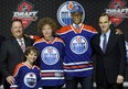 Darnell Nurse with Edmonton Oilers executives Scott Howson and Stu MacGregor at the 2013 NHL Draft. (Photo: Bill Kostroun/AP)