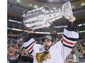 Chicago Blackhawks' goalie Corey Crawford raises the Stanley Cup. (Photo: Elise Amendola, AP)