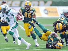 Saskatchewan Roughriders running back Kory Sheets breaks away from Edmonton Eskimos defenders at Commonwealth Stadium on Saturday afternoon.
Photograph by: John Lucas, Edmonton Journal