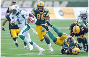 Saskatchewan Roughriders running back Kory Sheets breaks away from Edmonton Eskimos defenders at Commonwealth Stadium on Saturday afternoon.
Photograph by: John Lucas, Edmonton Journal