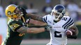 Toronto Argonauts’ Chad Owens (R) eludes Edmonton Eskimos’ Mathieu Bertrand during their CFL football game in Edmonton June 30, 2012. Edmonton Journal photo