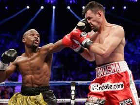 Floyd Mayweather Jr. lands a left jab against Robert Guerrero in the fourth round during a WBC welterweight title fight, Saturday, May 4, 2013, in Las Vegas. Photo by Isaac Brekken, Associated Press