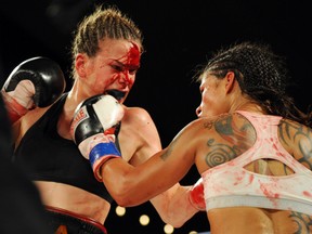 Jelena Mrdjenovich beats Melissa Hernandez for the WBC featherwieght world title after it was stopped because of a head butt and went to the score cards in the  KO boxing card Friday night at the Shaw Conference Centre in Edmonton , May 31, 2013. Photo by Bruce Edwards, Edmonton Journal