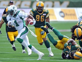 EDMONTON, ALBERTA, JUNE 29, 2013: Rider Kory Sheets runs riot in the first half during a game between the Edmonton Eskimos and Sask. Roughriders at Commonwealth stadium in Edmonton, Ab. on Saturday June. 29, 2013.  Photo by John Lucas/Edmonton Journal)(standalone)