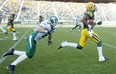 Edmonton Eskimos' Marcell Young (23) runs for a touchdown as Saskatchewan Roughriders' Rob Bagg (6) chases during first half pre-season action in Edmonton, Alta., on Friday June 14, 2013. THE CANADIAN PRESS/Jason Franson.