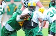 Edmonton Eskimos running back Tavoy Moore, who’s also a kick returner, breaks a tackle by JC Sherritt during Day 1 of training camp at Commonwealth Stadium on Sunday, June 2, 2013.
Photo by Bruce Edwards, Edmonton Journal