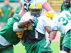 Edmonton Eskimos running back Tavoy Moore, who’s also a kick returner, breaks a tackle by JC Sherritt during Day 1 of training camp at Commonwealth Stadium on Sunday, June 2, 2013.
Photo by Bruce Edwards, Edmonton Journal