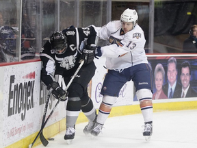 Curtis Hamilton separates an opponent from the puck. (Photo: Steven Christy/OKC Barons)