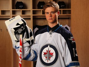 Eric Comrie poses for photos after the Winnipeg Jets drafted him in the second round of the 2013 NHL entry draft on June 30, 2013, in Newark, N.J.