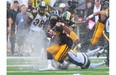 Hamilton Tiger-Cats’ Lindsey Lamar, front, is tackled by Edmonton Eskimos’ Calvin McCarthy, top, and Grant Shaw during first half CFL action in Guelph, Ont., on Sunday, July 7, 2013.
Photograph by: Aaron Lynett, THE CANADIAN PRESS