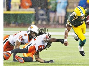 B.C. Lions Korey Banks and Joe Burnett miss the tackle on Edmonton Eskimos Hugh Charles during first half action in Edmonton.
Photograph by: JASON FRANSON, THE CANADIAN PRESS