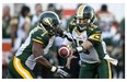 Edmonton Eskimos quarterback Mike Reilly hands off to running back Hugh Charles s they face the Montreal Alouettes during first quarter CFL football action Thursday, July 25, 2013 in Montreal.
Photograph by: Paul Chiasson, The Canadian Press