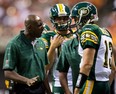 Edmonton Eskimos' head coach Kavis Reed, left, shouts at quarterback Mike Reilly after he came off the field after failing to gain the first down against the B.C. Lions during the second half of a CFL football game in Vancouver, B.C., on Saturday July 20, 2013. THE CANADIAN PRESS/Darryl Dyck