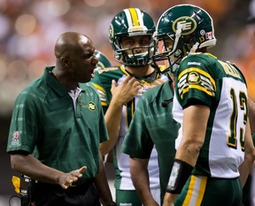 Edmonton Eskimos' head coach Kavis Reed, left, shouts at quarterback Mike Reilly after he came off the field after failing to gain the first down against the B.C. Lions during the second half of a CFL football game in Vancouver, B.C., on Saturday July 20, 2013. THE CANADIAN PRESS/Darryl Dyck