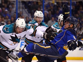 David Perron got the worst of this battle against some of the big bodies on the San Jose Sharks in the 2012 Stanley Cup playoffs. (Photo: Dilip Vishwanat/Getty Images North America)