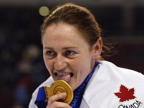 Canadian women's hockey team member Geraldine Heaney licks her gold medal after their win over the United States at the XIX Olympic Winter Games in Salt Lake City, Utah, on Feb 21, 2002. Geraldine Heaney is headed to the Hockey Hall of Fame. Heaney joins former NHL players Chris Chelios, Scott Niedermayer and Brendan Shanahan, while Fred Shero was selected in the builder category to round out the class of 2013. THE CANADIAN PRESS/Tom Hanson