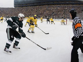 Lee Moffie (in yellow, defending the pass) played a couple of outdoor games during his time at University of Michigan, including The Big Chill vs. Michigan State. (Photo: Gregory Shamus/Getty Images North America)