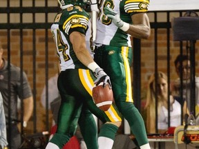 Edmonton Eskimos slotback Cary Koch, left, celebrates his touchdown with teammate Marcus Henry as they face the Montreal Alouettes during fourth quarter CFL football action Thursday, July 25, 2013 in Montreal. The Alouettes beat the Eskimos 32-27. THE CANADIAN PRESS/Paul Chiasson