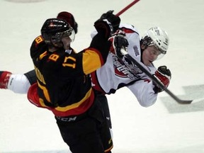 Windsor Spitfires Ben Johnson is sent flying during a hit by Belleville Bulls Daniil Zharkov during second period Ontario Hockey League action at the WFCU Centre in Windsor, Ontario on December 8, 2011. (Photo: windsorstar.com)