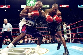 Evander Holyfield (left) battled Mike Tyson on June 28, 1997 in the infamous fight that ended with Tyson getting disqualified for biting Holyfield's ear.