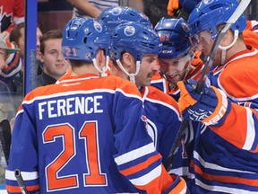Defenceman Andrew Ference, left, celebrates an Edmonton Oilers goal with his tammates during a pre-season game against the visiting Winnipeg Jets on Sept. 23, 2013. Ference was named the captain of the Oilers late on Sept. 28.