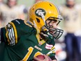 Edmonton Eskimos quarterback Mike Reilly #13 makes a run against the Winnipeg Blue Bombers during first half action in Edmonton, Alta., on Saturday September 14, 2013. THE CANADIAN PRESS/Jason Franson