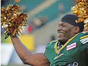 Odell Willis #41 celebrates with cheerleaders pom poms after the Edmonton Eskimos beat the Winnipeg Blue Bombers 25-7 at Commonwealth stadium in Edmonton, September 14, 2013.
Photograph by: Bruce Edwards, Edmonton Journal