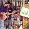 Corb Lund serenades shoppers during the first evening of his garage sale in Edmonton.