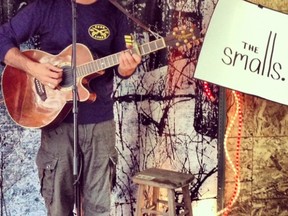 Corb Lund serenades shoppers during the first evening of his garage sale in Edmonton.