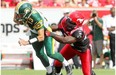 Calgary Stampeders Cordarro Law, right tackles Edmonton Eskimos quarterback Mike Reilly during the Labour day Classic at McMahon Stadium in Calgary, Alberta on September 02, 2013.
Photograph by: Leah Hennel, Calgary Herald