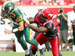 Calgary Stampeders Cordarro Law, right tackles Edmonton Eskimos quarterback Mike Reilly during the Labour day Classic at McMahon Stadium in Calgary, Alberta on September 02, 2013.
Photograph by: Leah Hennel, Calgary Herald