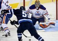 Winnipeg Jets forward Mark Scheifele skates in to shoot on Edmonton Oilers goalie Richard Bachman during first period pre-season action on Sept. 17, 2013, in Winnipeg.