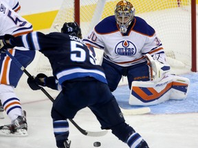 Winnipeg Jets forward Mark Scheifele skates in to shoot on Edmonton Oilers goalie Richard Bachman during first period pre-season action on Sept. 17, 2013, in Winnipeg.