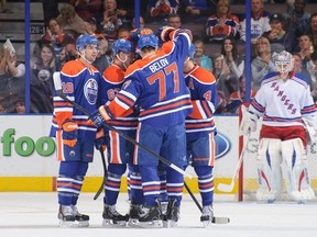 EDMONTON, AB - SEPTEMBER 24: Taylor Hall #4 of the Edmonton Oilers celebrates his goal against Martin Biron #43 of the New York Rangers along with his teammates Justin Schultz #19, Anton Belov #77 and Ales Hemsky #83 during a preseason NHL game at Rexall Place on September 24, 2013 in Edmonton, Alberta, Canada. (Photo by Derek Leung/Getty Images)