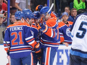 Edmonton Oilers (L-R) Andrew Ference, Mike Brown, Will Acton, and Anton Belov celebrate a goal against Winnipeg earlier this week, while Jason LaBarbera looks on from the bench. All but Brown are new to the Oilers in 2013-14. (Photo: Derek Leung/Getty Images North America)