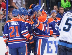 Edmonton Oilers (L-R) Andrew Ference, Mike Brown, Will Acton, and Anton Belov celebrate a goal against Winnipeg earlier this week, while Jason LaBarbera looks on from the bench. All but Brown are new to the Oilers in 2013-14. (Photo: Derek Leung/Getty Images North America)