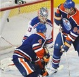 Taylor Hall tips in Edmonton Oilers' first goal while Ryan Smyth provides traffic. (Photograph by: Ed Kaiser, Edmonton Journal)