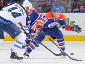 Winnipeg Jets forward Zach Bogosian is checked by Edmonton Oilers forward Ryan Hamilton on Sept. 23, 2013, during a preseason game at Rexall Place.