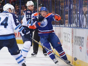 Winnipeg Jets centre Chris Thorburn stops Edmonton Oilers winger Ryan Jones  from skating to the puck during the pre-season game between the two clubs at Rexall Place on Monday, Sept. 23, 2013. Jones was waived by the Oilers on Sept. 25.