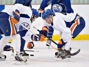 Edmonton Oilers Ryan Smyth, left, and Taylor Hall practise face-offs during training camp in Sherwood Park, Alta., on Sept. 12, 2013.