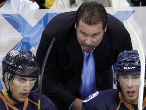 Head coach Todd Nelson of the Oklahoma City Barons talks with players Jordan Eberle, left, and Ryan Nugent-Hopkins during their game against the Lake Erie Monsters on Oct. 12, 2012, in Cleveland.