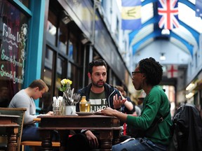 Diners enjoy a meal in Brixton Village in London (not pictured: a server). Carl Court/AFP/Getty Images.